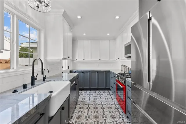 a kitchen with a sink appliances and cabinets