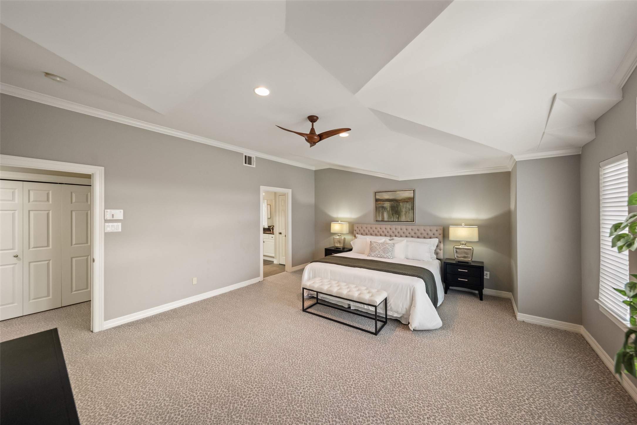2708 Wroxton Road West University Place, TX 77005 - Photo 6 of 22 Spacious primary suite enhanced by elegant architectural details and a stylish ceiling fan.