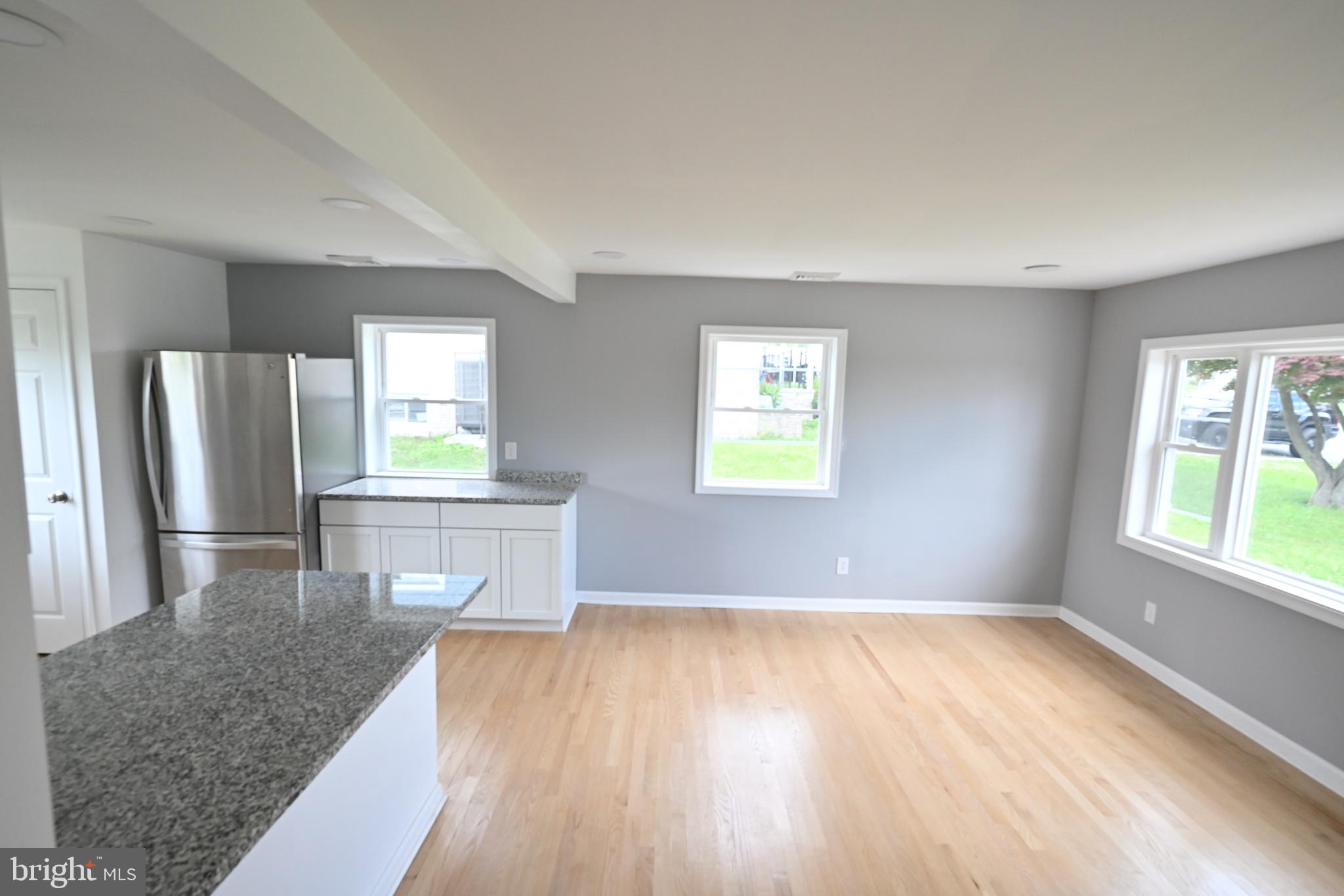 34 Compass Road East Middle River, MD 21220 - Photo 10 of 25 a view of a kitchen with wooden floor and a window