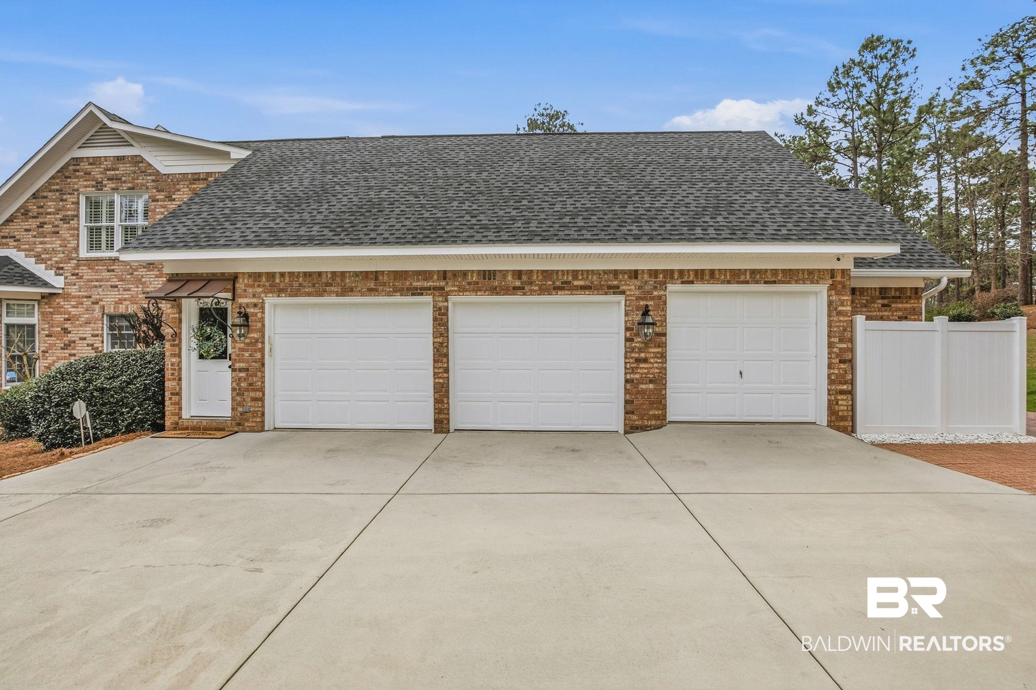 31515 Rhett Drive Spanish Fort, AL 36527 - Photo 67 of 100 The garage has an epoxy floor, EV charger, custom cabinets and workspace. The third bay is currently being used as a workshop. There is a separate door with stairs leading up to the second floor.
