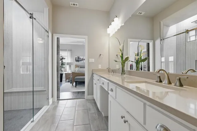a bathroom with a double vanity sink and a mirror