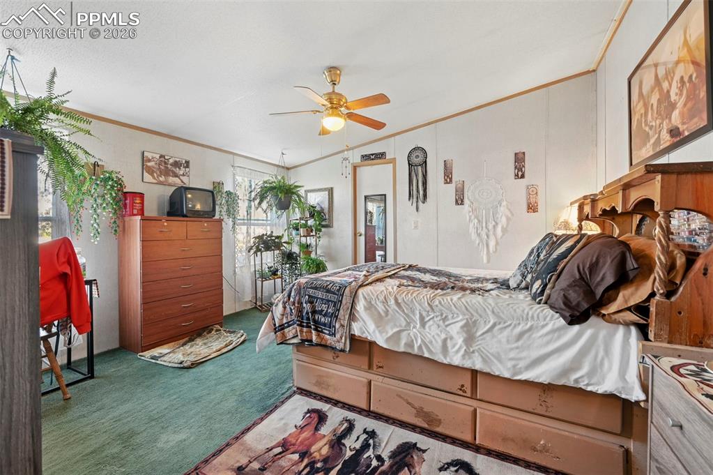 35875 Shear Road Yoder, CO 80864 - Photo 22 of 45 a bedroom with a bed and a fan