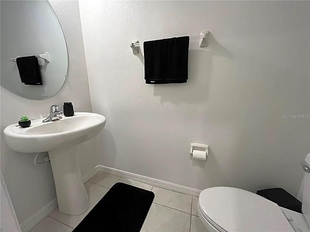 31751 Blue Passing Loop Wesley Chapel, FL 33545 - Photo 14 of 18 a bathroom with a sink toilet and mirror