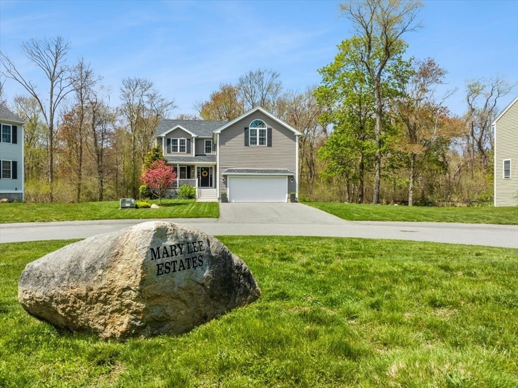 a view of a house with a big yard plants and large trees