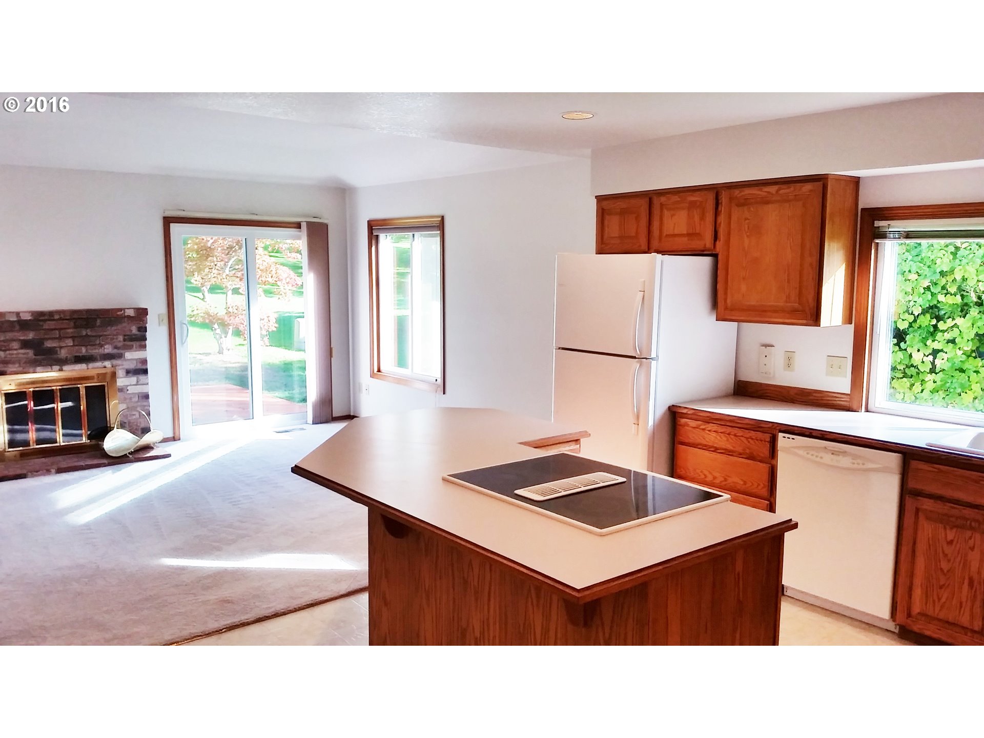 1173 Northwest Weybridge Way Beaverton, OR 97006 - Photo 5 of 12 a kitchen with stainless steel appliances kitchen island a sink dishwasher a stove and a refrigerator