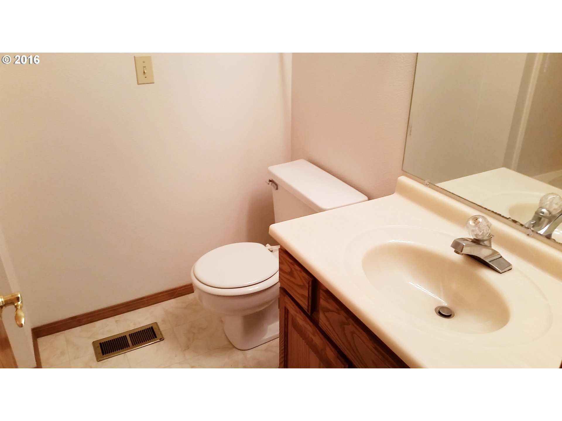 1173 Northwest Weybridge Way Beaverton, OR 97006 - Photo 8 of 12 a bathroom with a sink toilet and mirror