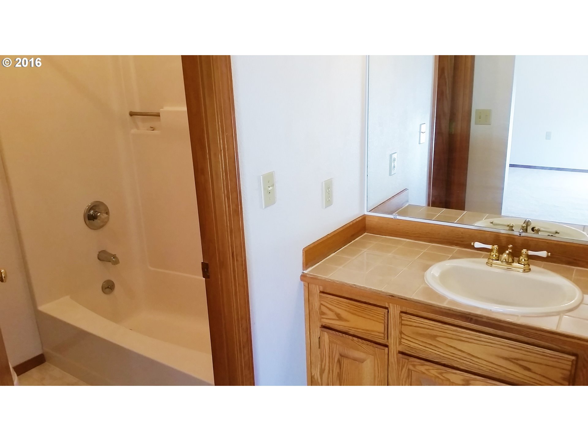 1173 Northwest Weybridge Way Beaverton, OR 97006 - Photo 10 of 12 a bathroom with a sink a mirror and a bathtub