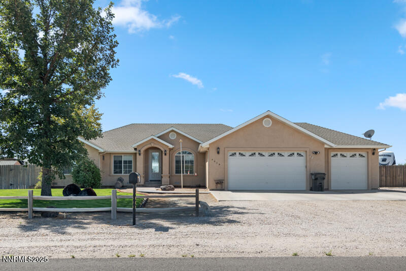 4609 Rancheria Road Fallon, NV 89406 - Photo 1 of 25 a front view of a house with a garden