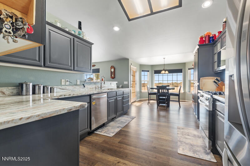 4609 Rancheria Road Fallon, NV 89406 - Photo 11 of 25 a kitchen with sink refrigerator dining table and chairs