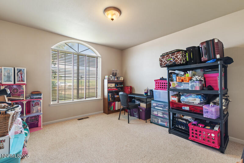 4609 Rancheria Road Fallon, NV 89406 - Photo 17 of 25 a room with furniture and a book shelf