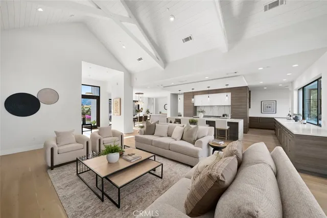 a living room with furniture a rug and a large window