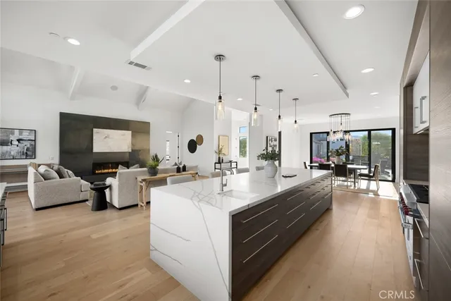 a bathroom with a sink and mirror with bathtub