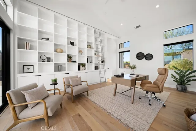 a bedroom with a bed and a large window with the outer view