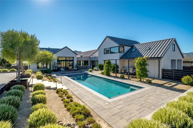 a living room with furniture large window and flat screen tv