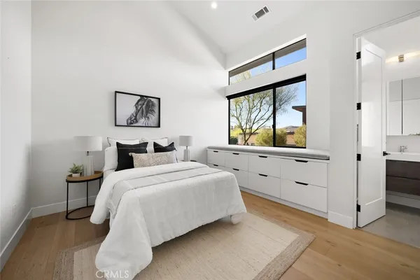 a bedroom with a large bed and a large window