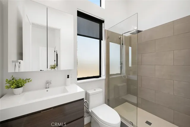 a spacious bathroom with a double vanity sink a mirror and a bathtub