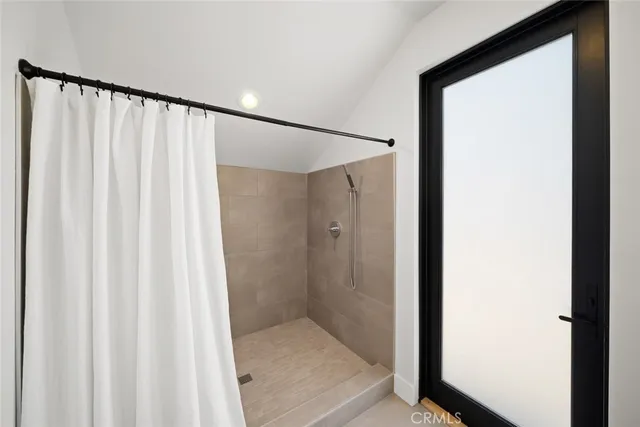 a bedroom with a bed and a large mirror