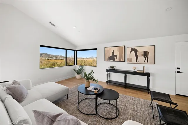 a view of a house with a yard and potted plants