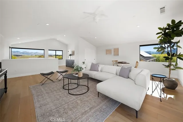 an aerial view of residential houses with outdoor space and ocean view