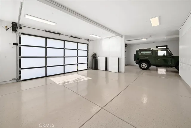 a front view of a house with a yard and potted plants