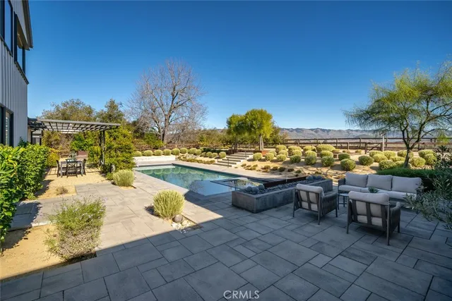 a view of a swimming pool with an outdoor seating
