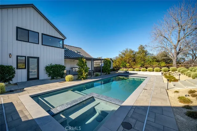 a living room with furniture kitchen view and a window