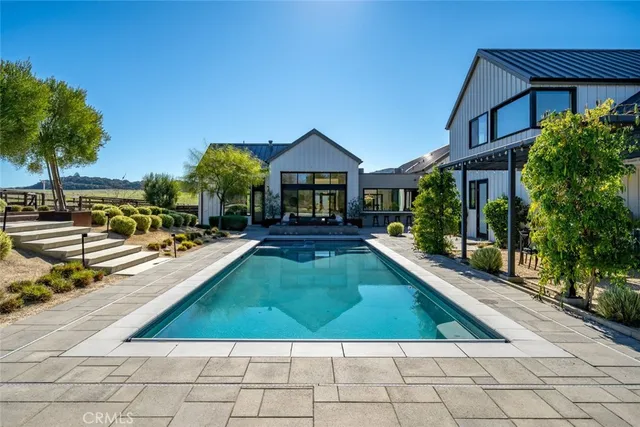 a dining room with furniture a chandelier and wooden floor