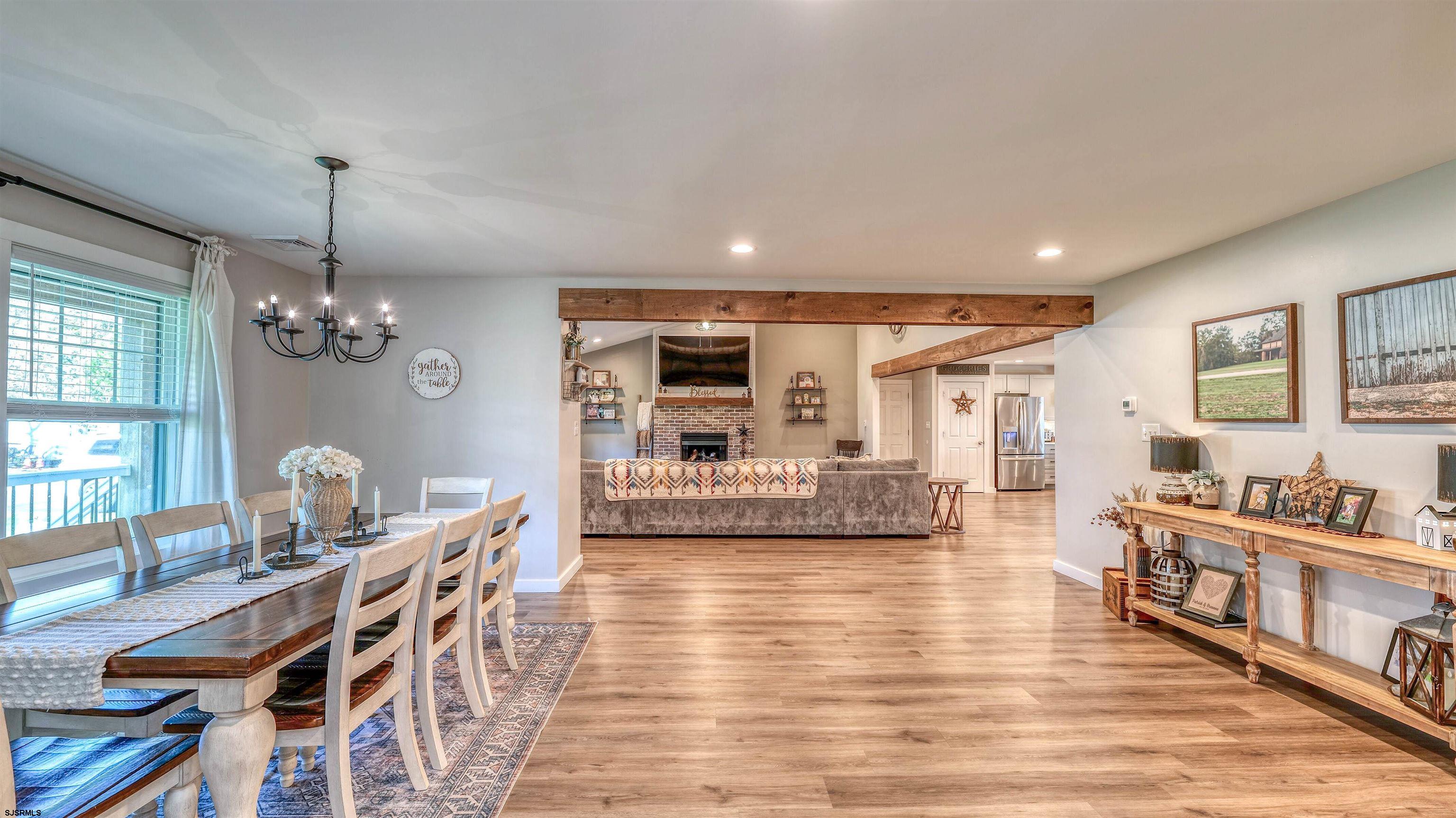 130 Stage Road Little Egg Harbor, NJ 08087 - Photo 24 of 50 a living room with furniture dining table and a chandelier