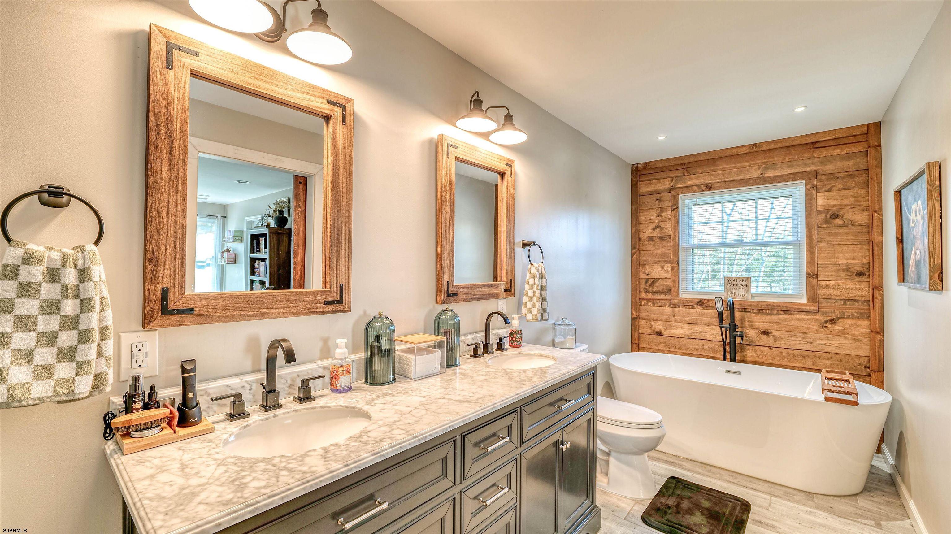 130 Stage Road Little Egg Harbor, NJ 08087 - Photo 32 of 50 a bathroom with a granite countertop double vanity sink a mirror and a bathtub