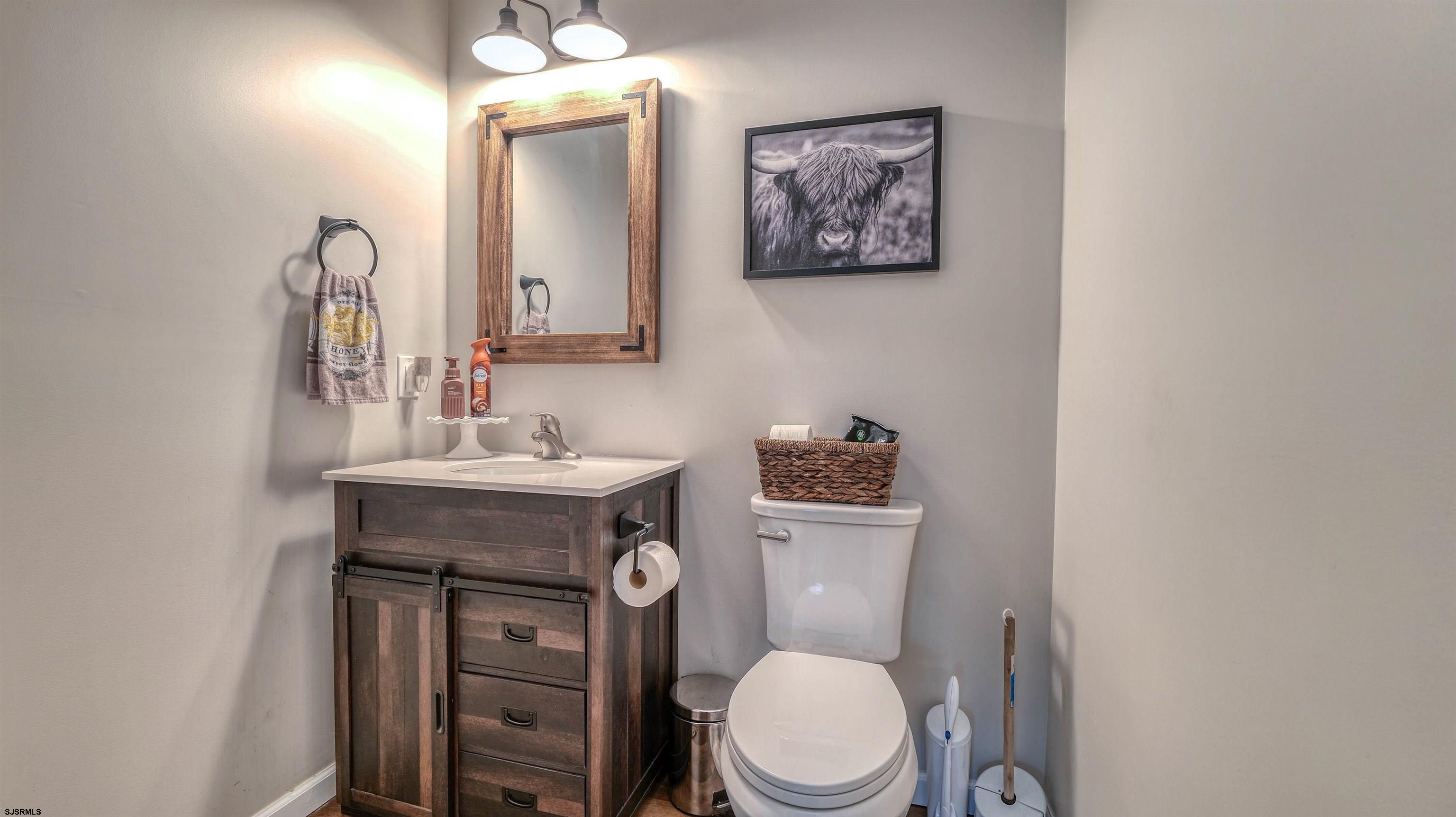 130 Stage Road Little Egg Harbor, NJ 08087 - Photo 36 of 50 a bathroom with a toilet a sink and mirror