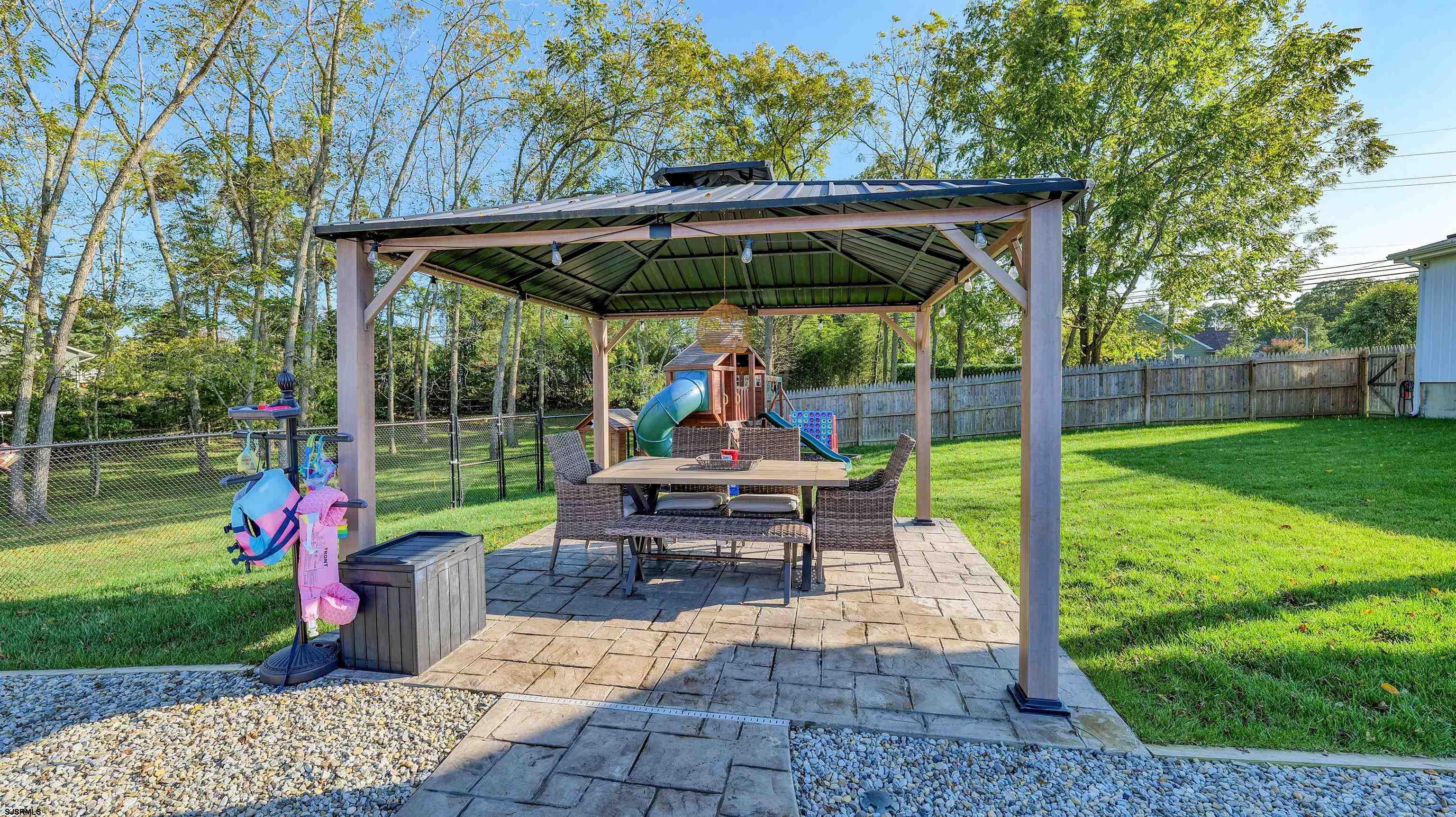 130 Stage Road Little Egg Harbor, NJ 08087 - Photo 44 of 50 a view of a patio with a table chairs and a yard