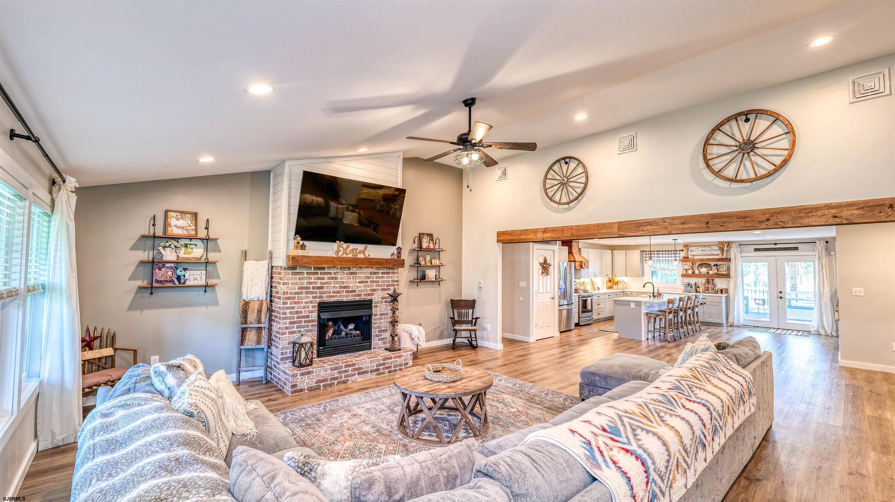 130 Stage Road Little Egg Harbor, NJ 08087 - Photo 9 of 50 a living room with furniture a fireplace and a flat screen tv