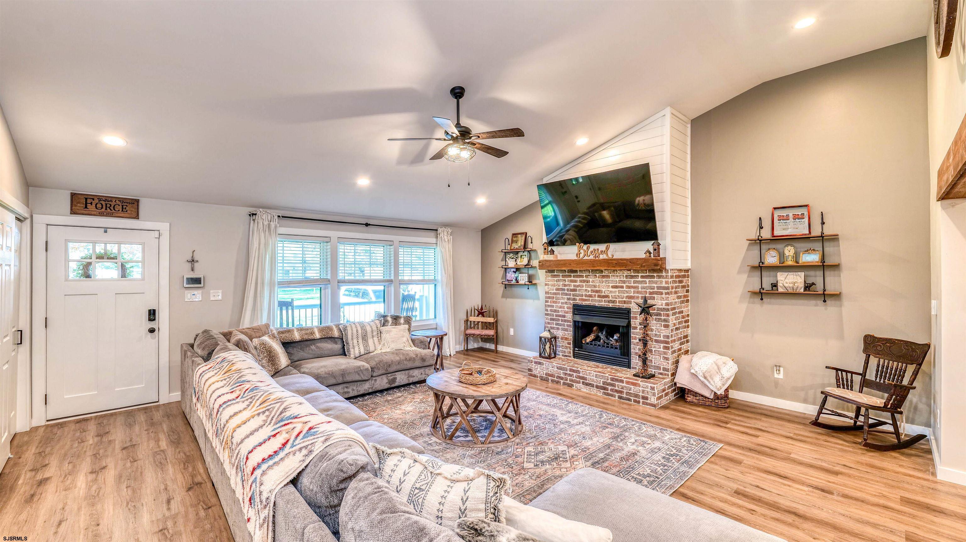 130 Stage Road Little Egg Harbor, NJ 08087 - Photo 10 of 50 a living room with furniture a fireplace and a flat screen tv