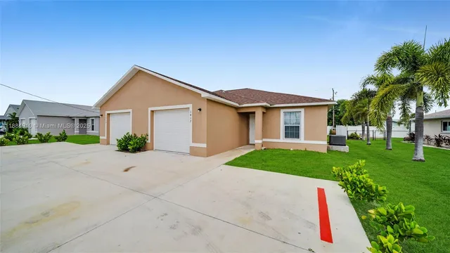 a front view of a house with a yard and garage