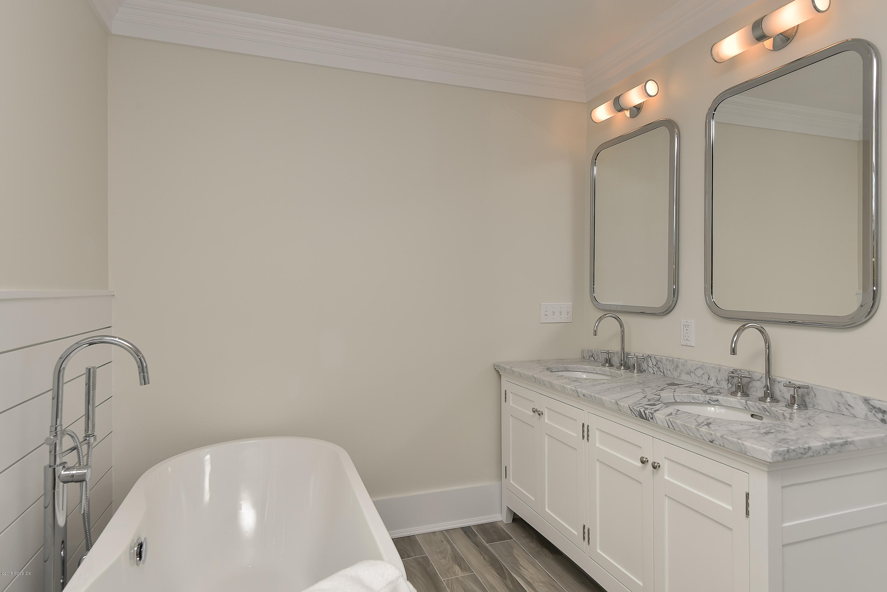 30 Edgewood Road Darien, CT 06820 - Photo 21 of 28 a bathroom with a double vanity sink and a mirror