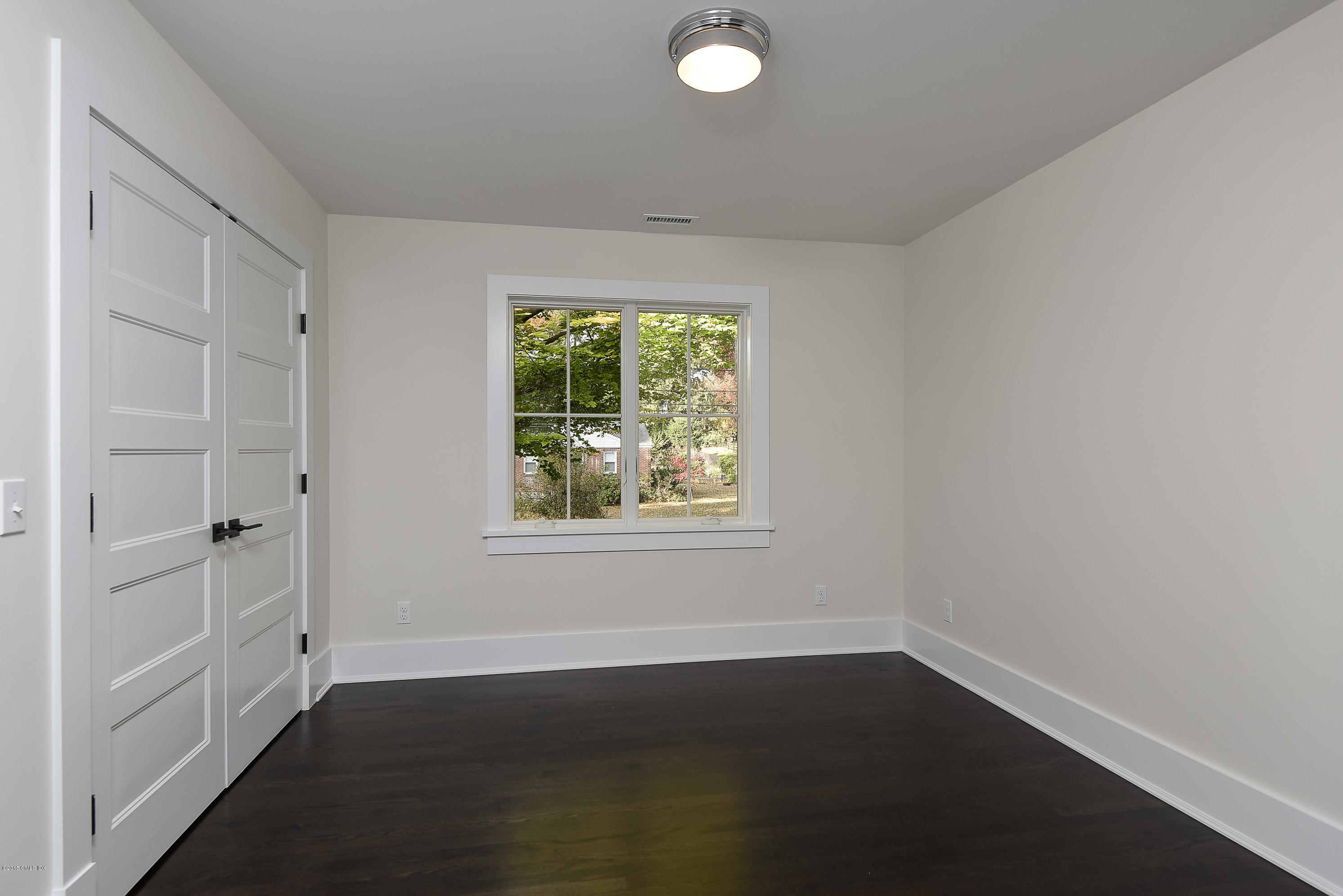 30 Edgewood Road Darien, CT 06820 - Photo 24 of 28 an empty room with wooden floor and windows