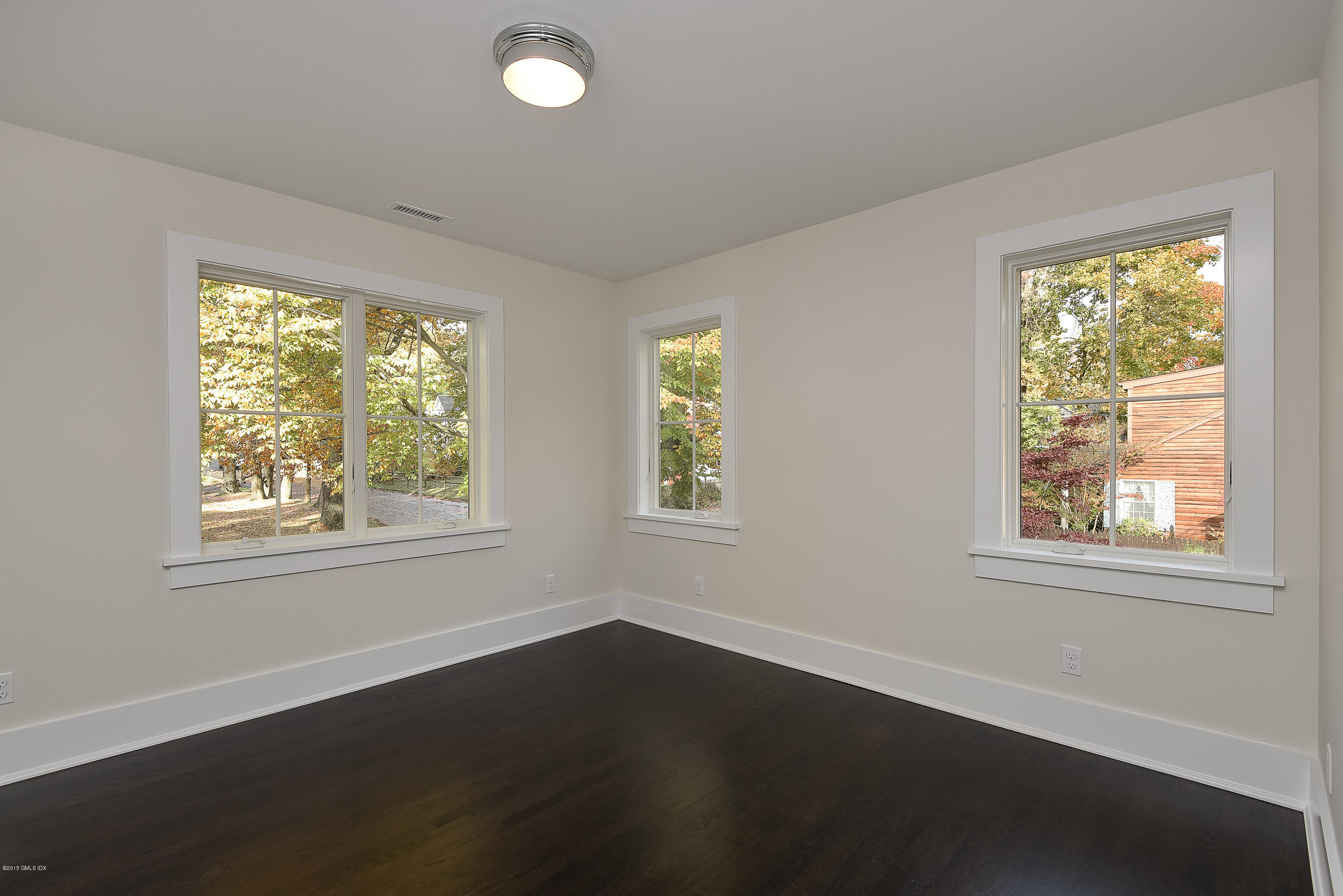 30 Edgewood Road Darien, CT 06820 - Photo 25 of 28 a view of an empty room with wooden floor and a window