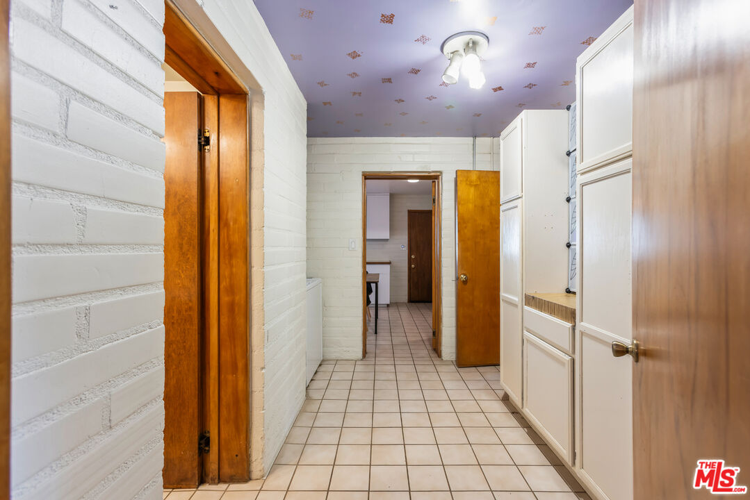4620 Cover Street Riverside, CA 92506 - Photo 12 of 42 a view of a hallway with wooden shelves