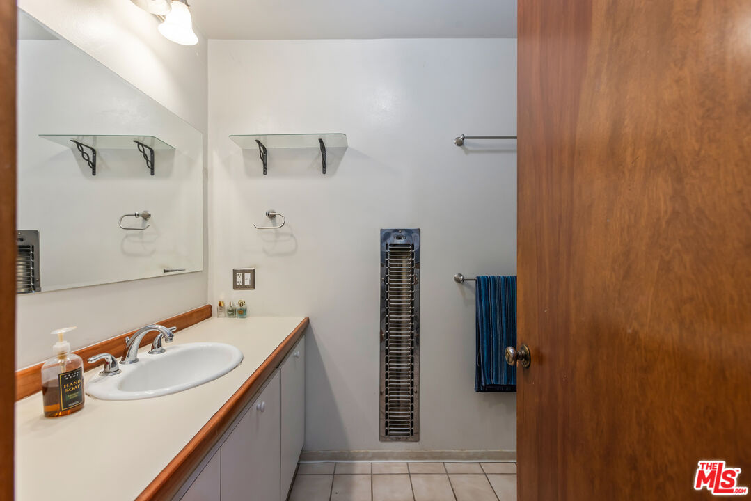 4620 Cover Street Riverside, CA 92506 - Photo 13 of 42 a bathroom with a sink and mirror