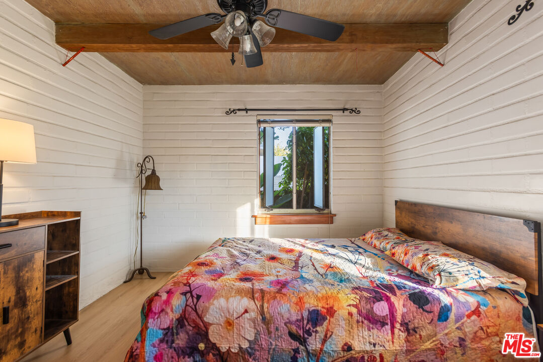 4620 Cover Street Riverside, CA 92506 - Photo 23 of 42 a bedroom with a bed and a chandelier