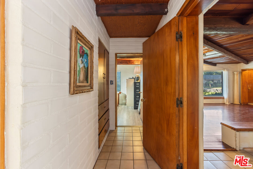 4620 Cover Street Riverside, CA 92506 - Photo 28 of 42 a view of a hallway with wooden floor and a bathroom