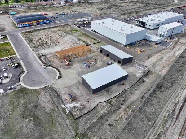 an aerial view of a residential houses with outdoor space