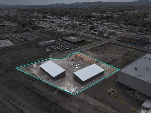 an aerial view of a residential apartment building with a yard