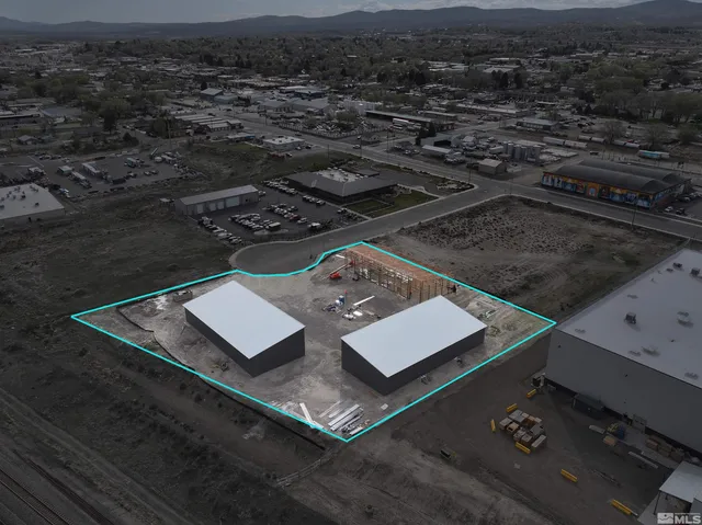 an aerial view of a residential apartment building with a yard
