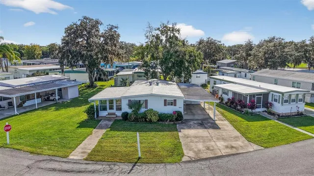 a front view of a house with yard and green space