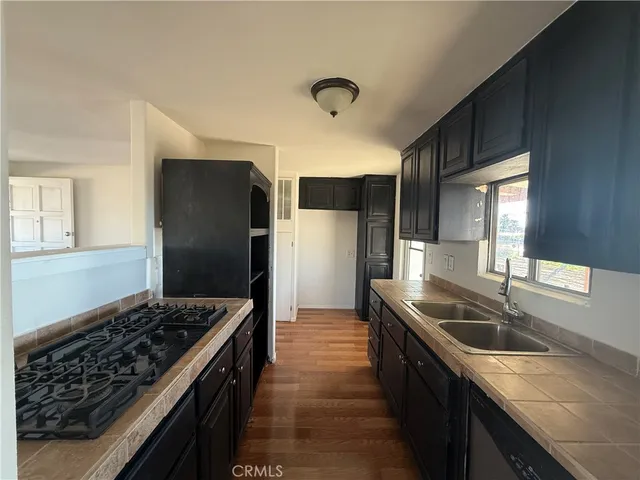 a kitchen with granite countertop a sink stove and refrigerator