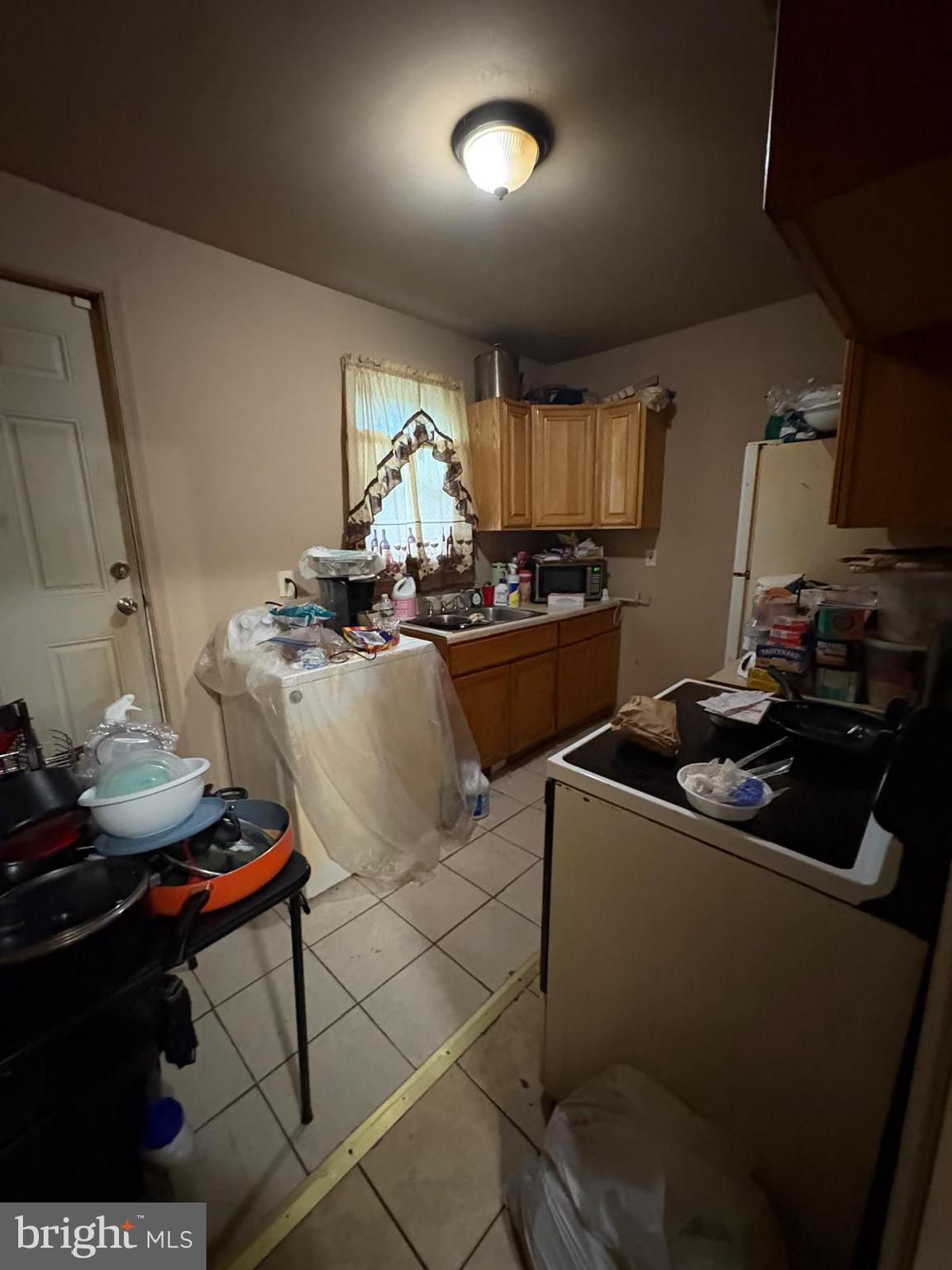 2832 Ormes Street Philadelphia, PA 19134 - Photo 9 of 28 a kitchen with a sink stove and cabinets