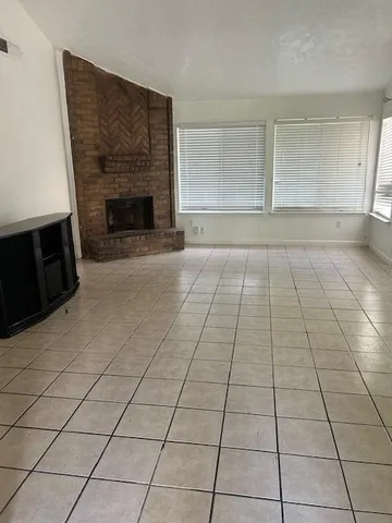 a view of an empty room with a fireplace