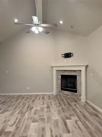 an empty room with a fireplace and fan