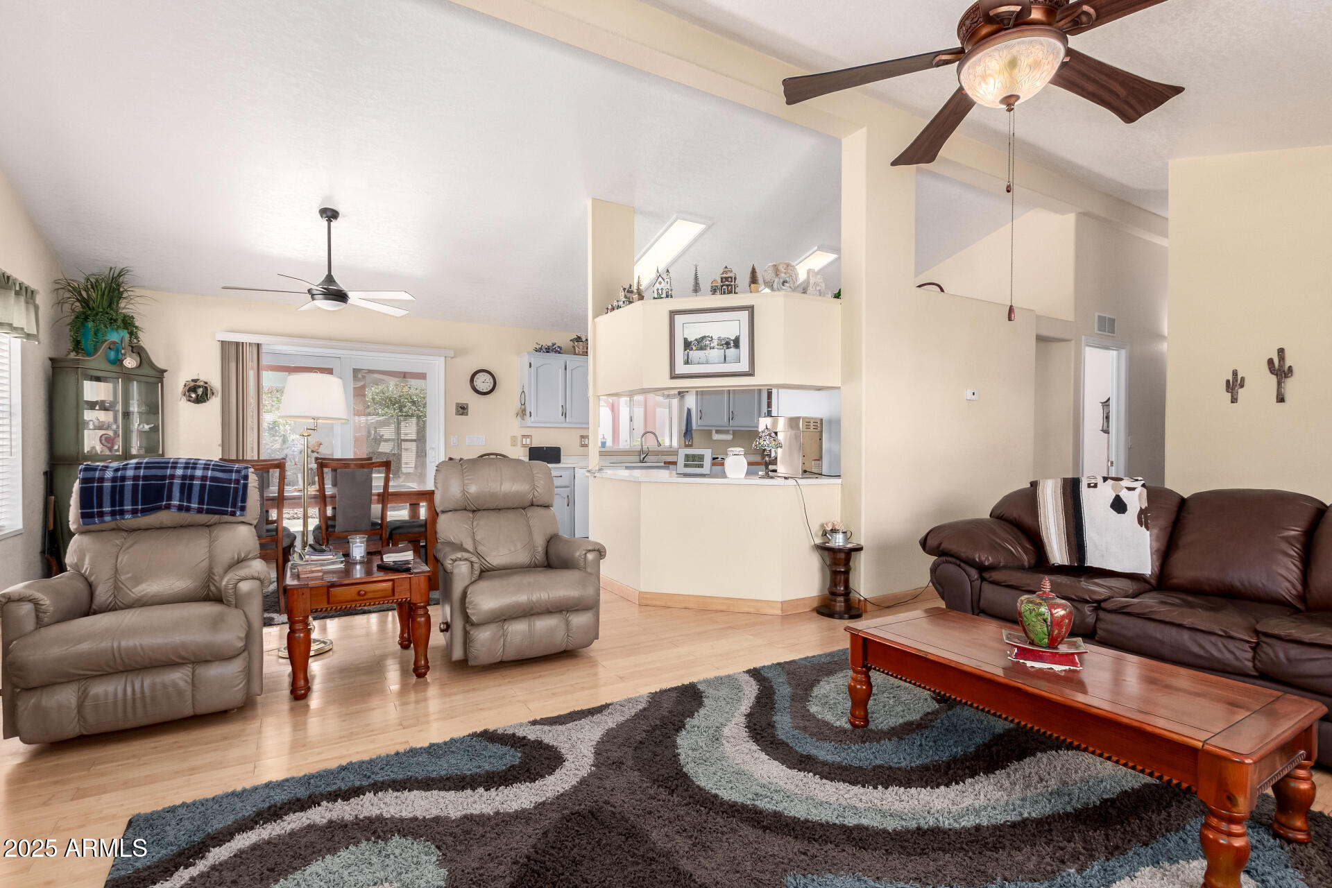 2101 South Meridian Road, Unit 60 Apache Junction, AZ 85120 - Photo 11 of 35 a living room with furniture and a chandelier